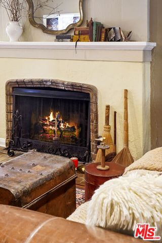 a living room with furniture a bookshelf and a large window