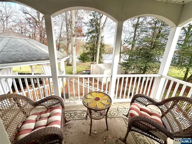 a view of backyard with a deck and trees