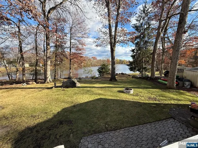 a view of backyard with large trees