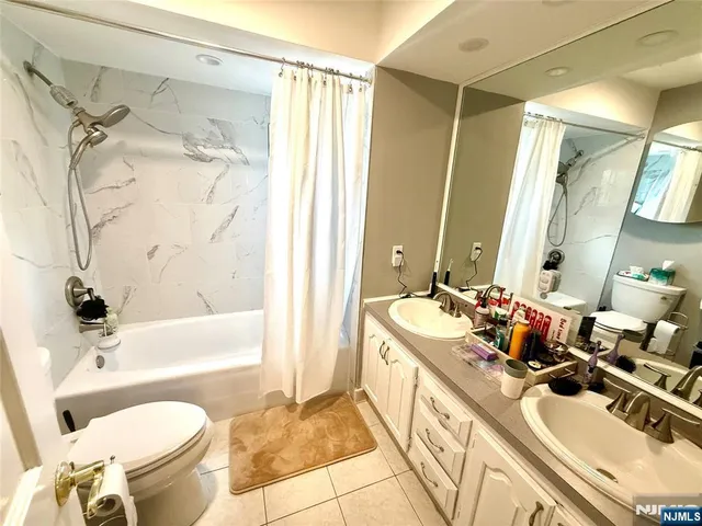 a bathroom with a granite countertop shower and a toilet