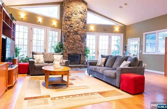 a living room with furniture a large window and a fireplace