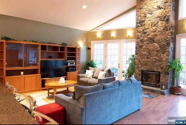 a living room with furniture a fireplace and a flat screen tv