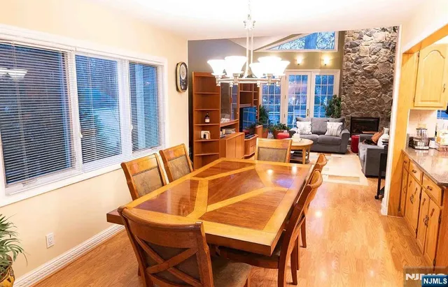 a bedroom with a bed a chandelier and a large window