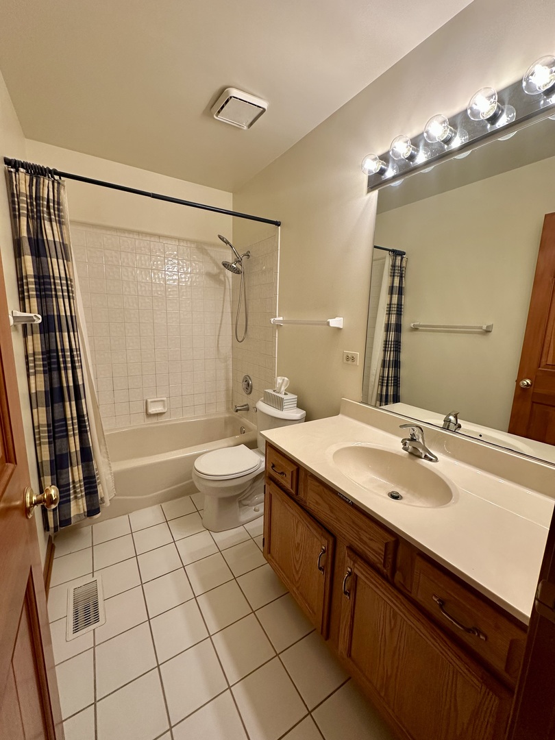4216 White Ash Road Crystal Lake, IL 60014 - Photo 24 of 34 a spacious bathroom with a double vanity sink a toilet a mirror and shower