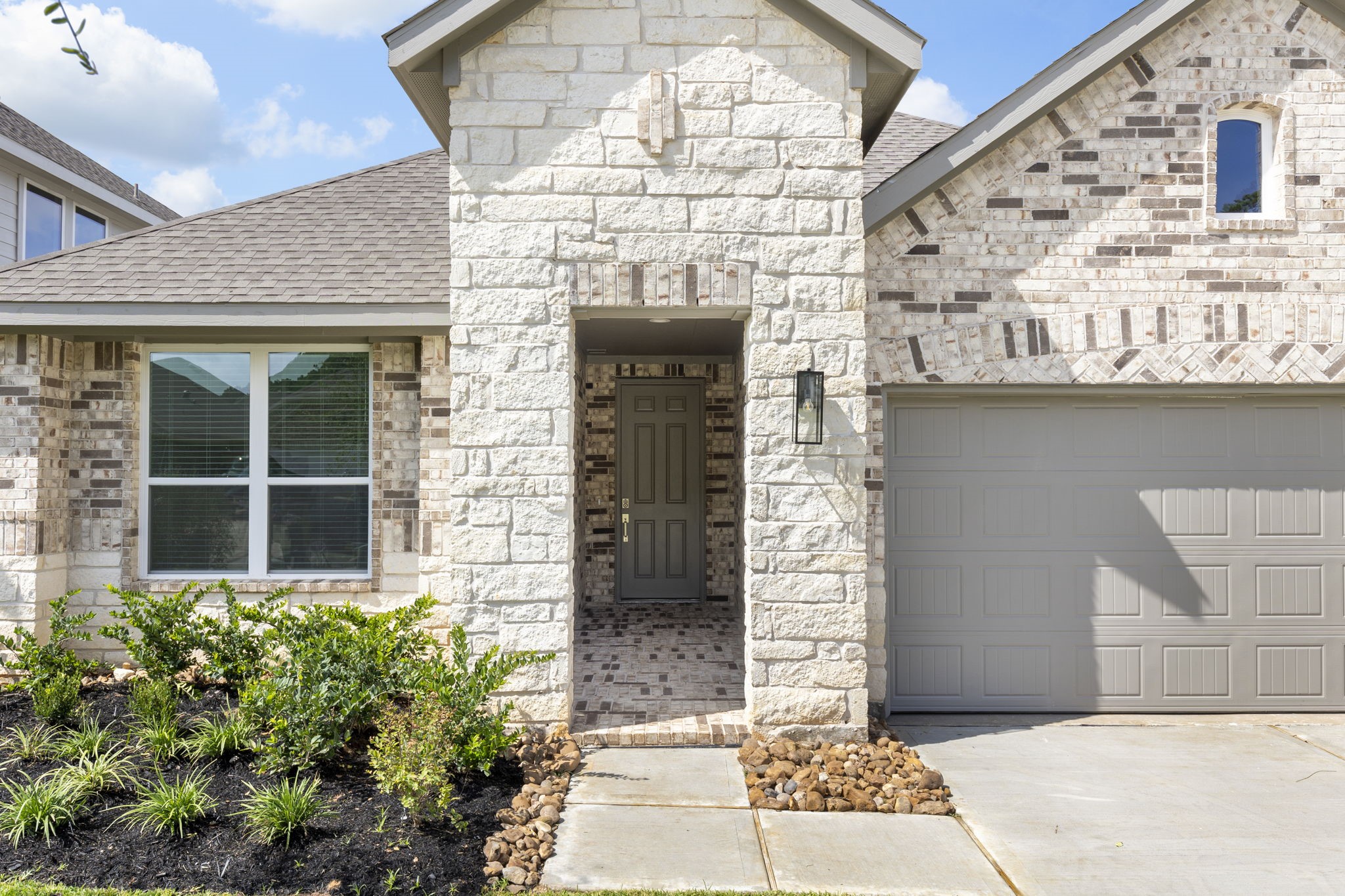 1589 Oakdale Crest Road Montgomery, TX 77316 - Photo 4 of 33 Brick and stone front exterior with a covered, brick-laid front porch.