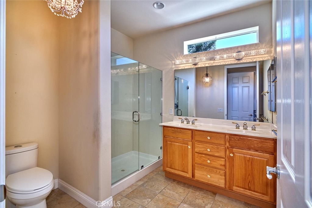 1143 Saguara Road Beaumont, CA 92223 - Photo 49 of 66 a bathroom with a double vanity sink toilet mirror and bathtub