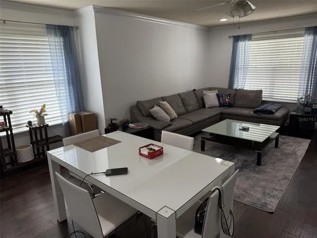 a living room with furniture and next to a window