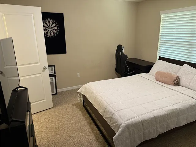 a bed room with a bed and a television