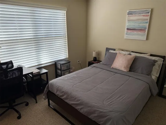 a bedroom with a bed and a desk