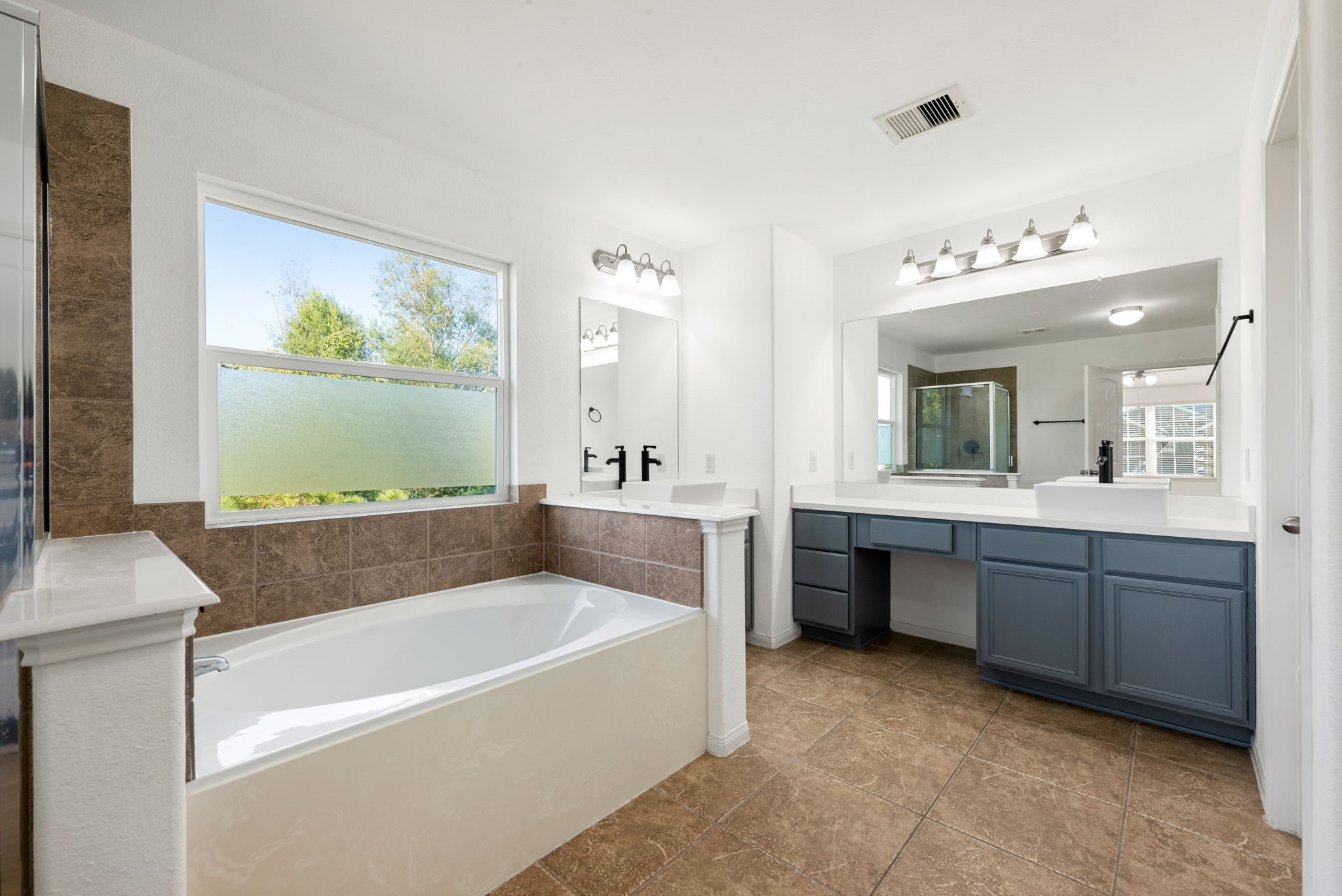 30802 Lavender Trace Drive Spring, TX 77386 - Photo 15 of 30 a bathroom with a tub a sink and mirror