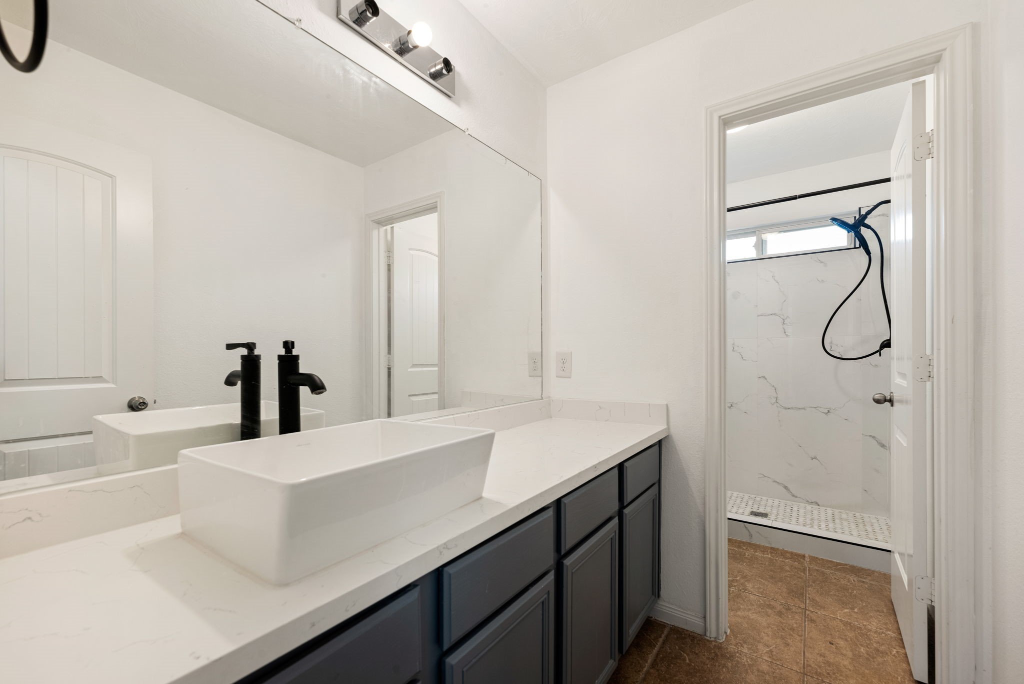 30802 Lavender Trace Drive Spring, TX 77386 - Photo 20 of 30 a bathroom with a sink vanity granite tub shower and a mirror