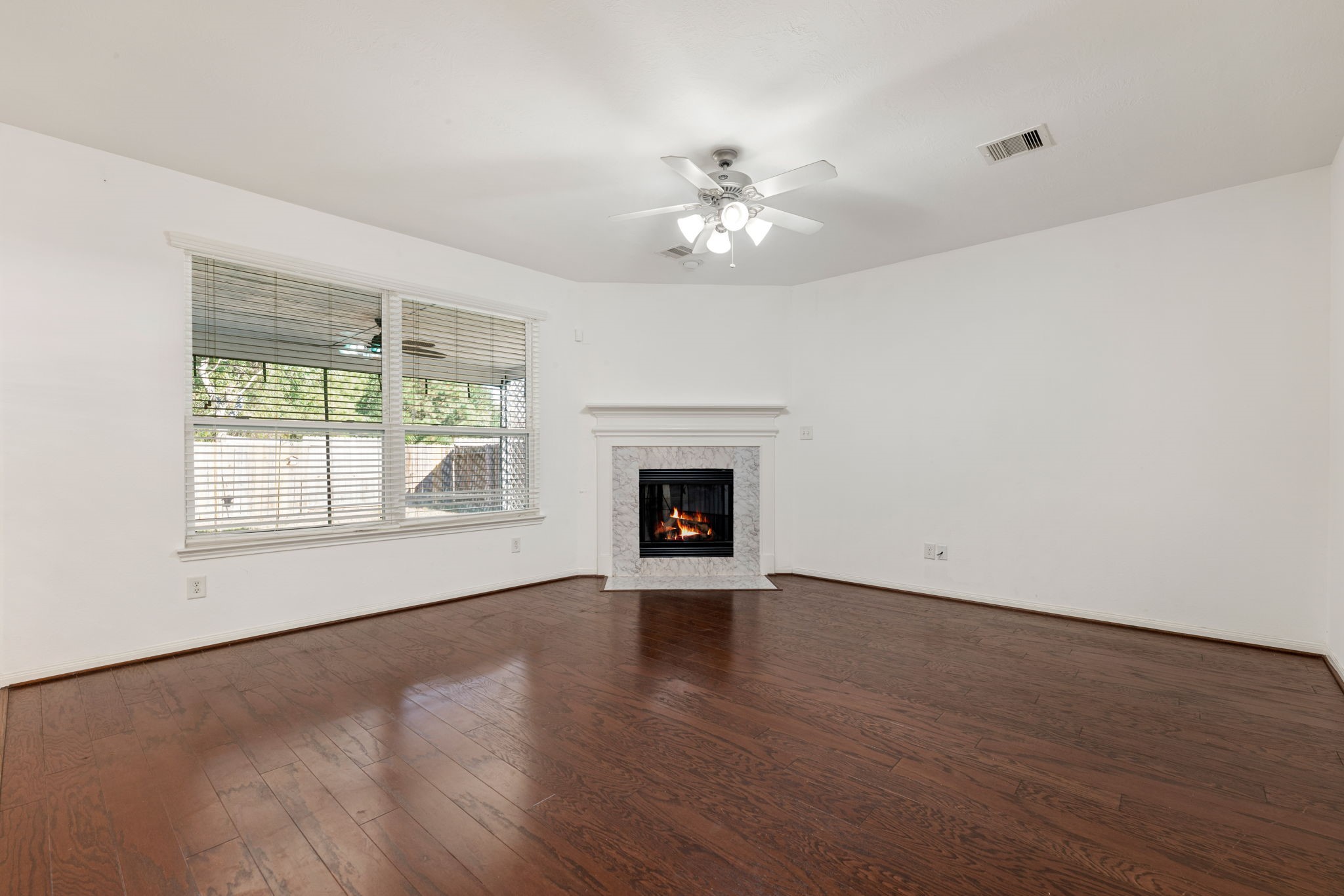 30802 Lavender Trace Drive Spring, TX 77386 - Photo 5 of 30 a view of an empty room with wooden floor and a window