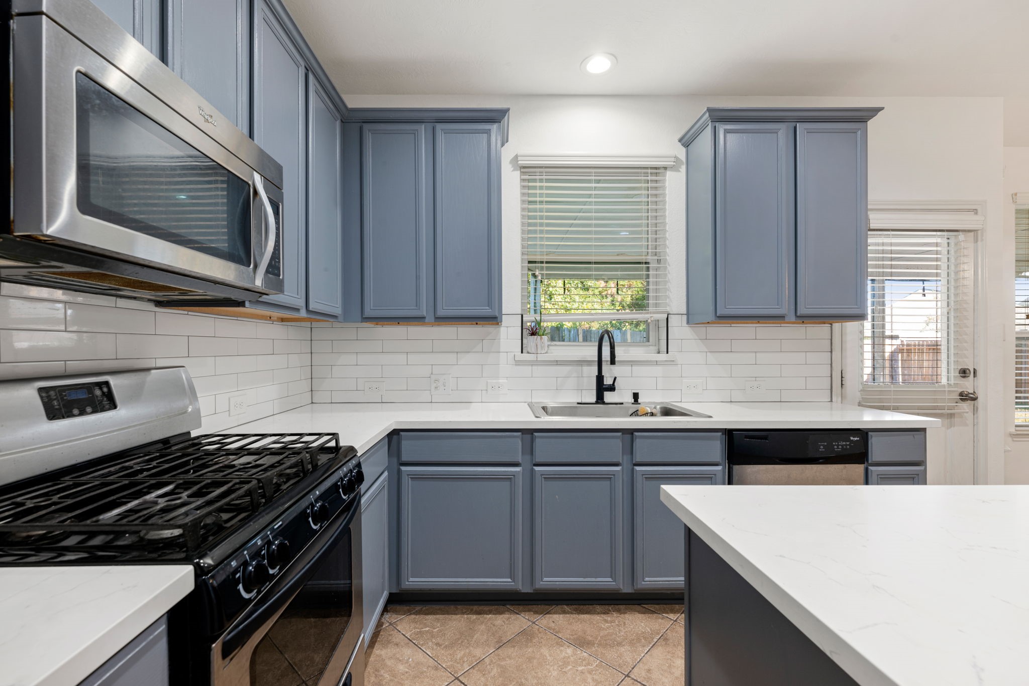 30802 Lavender Trace Drive Spring, TX 77386 - Photo 8 of 30 a kitchen with a sink stove top oven and cabinets