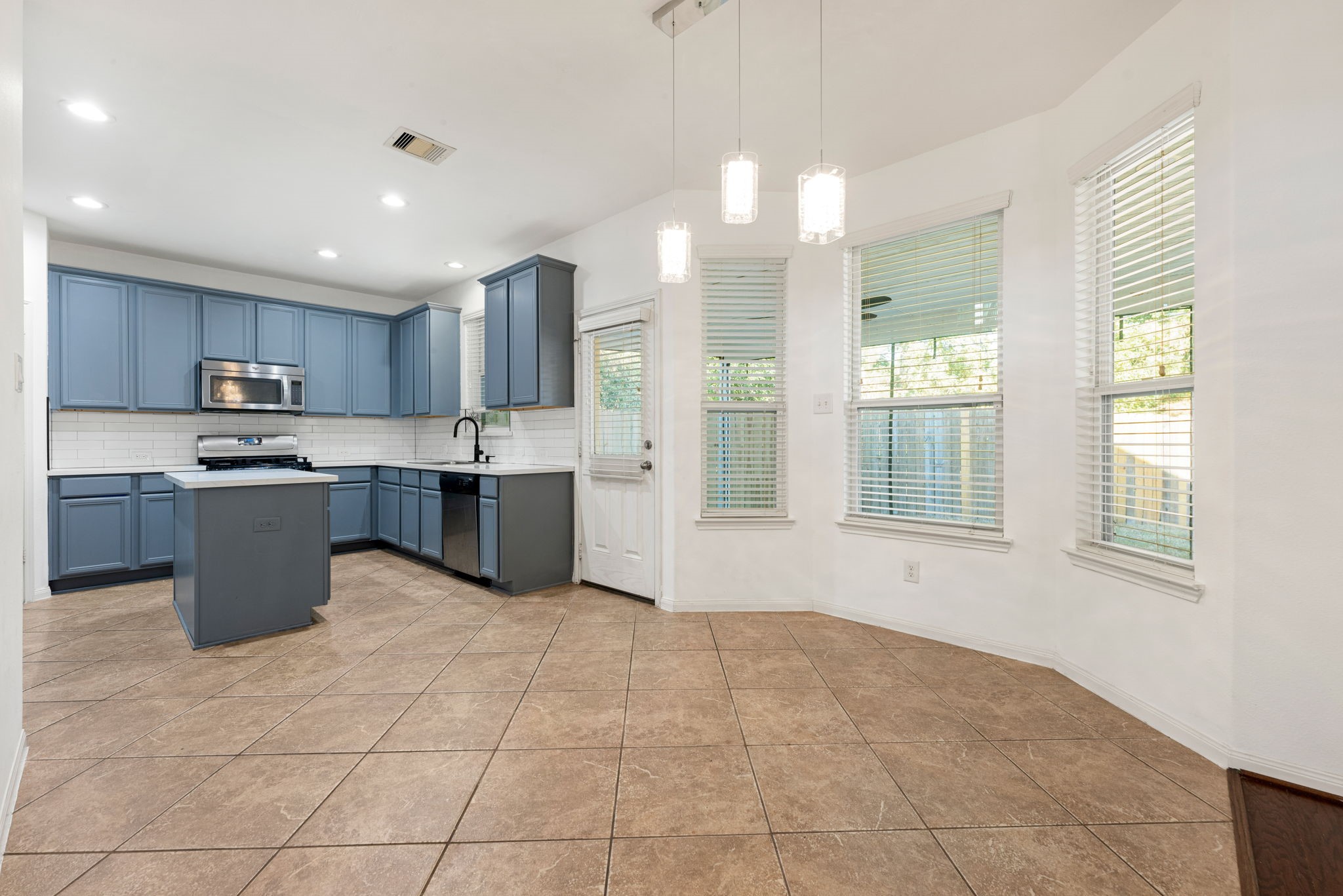 30802 Lavender Trace Drive Spring, TX 77386 - Photo 9 of 30 a large kitchen with cabinets and stainless steel appliances