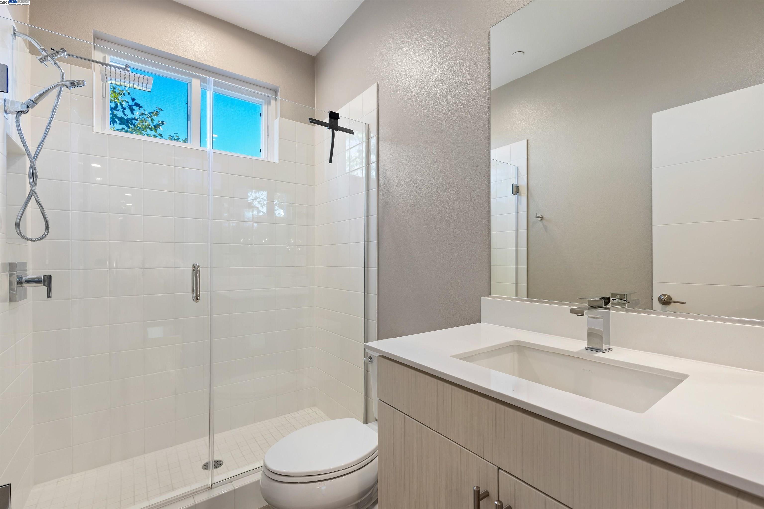 3957 Wattling Street Oakland, CA 94601 - Photo 12 of 23 a bathroom with a sink a toilet and shower