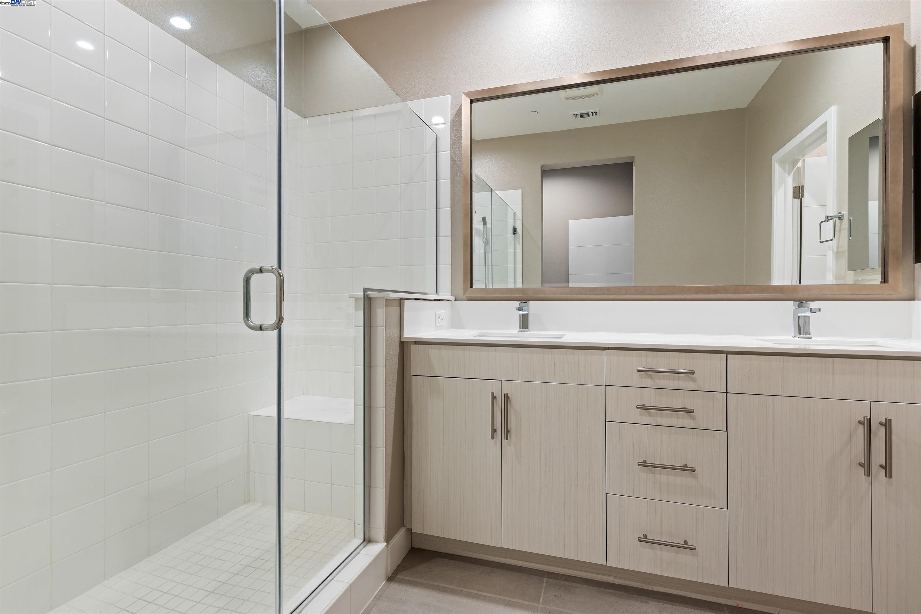 3957 Wattling Street Oakland, CA 94601 - Photo 18 of 23 a bathroom with double sink and a mirror