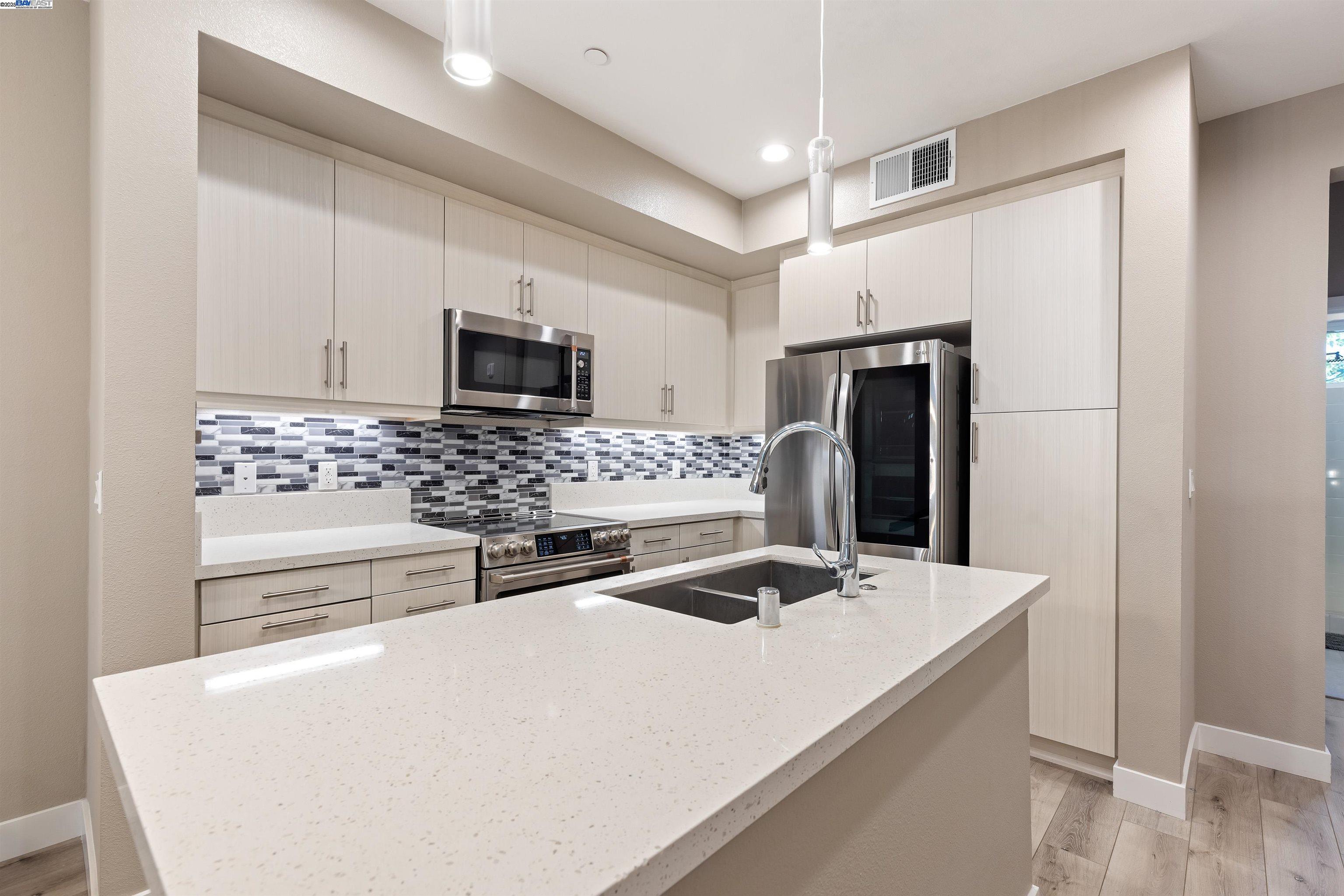 3957 Wattling Street Oakland, CA 94601 - Photo 7 of 23 a kitchen with stainless steel appliances a refrigerator and a stove
