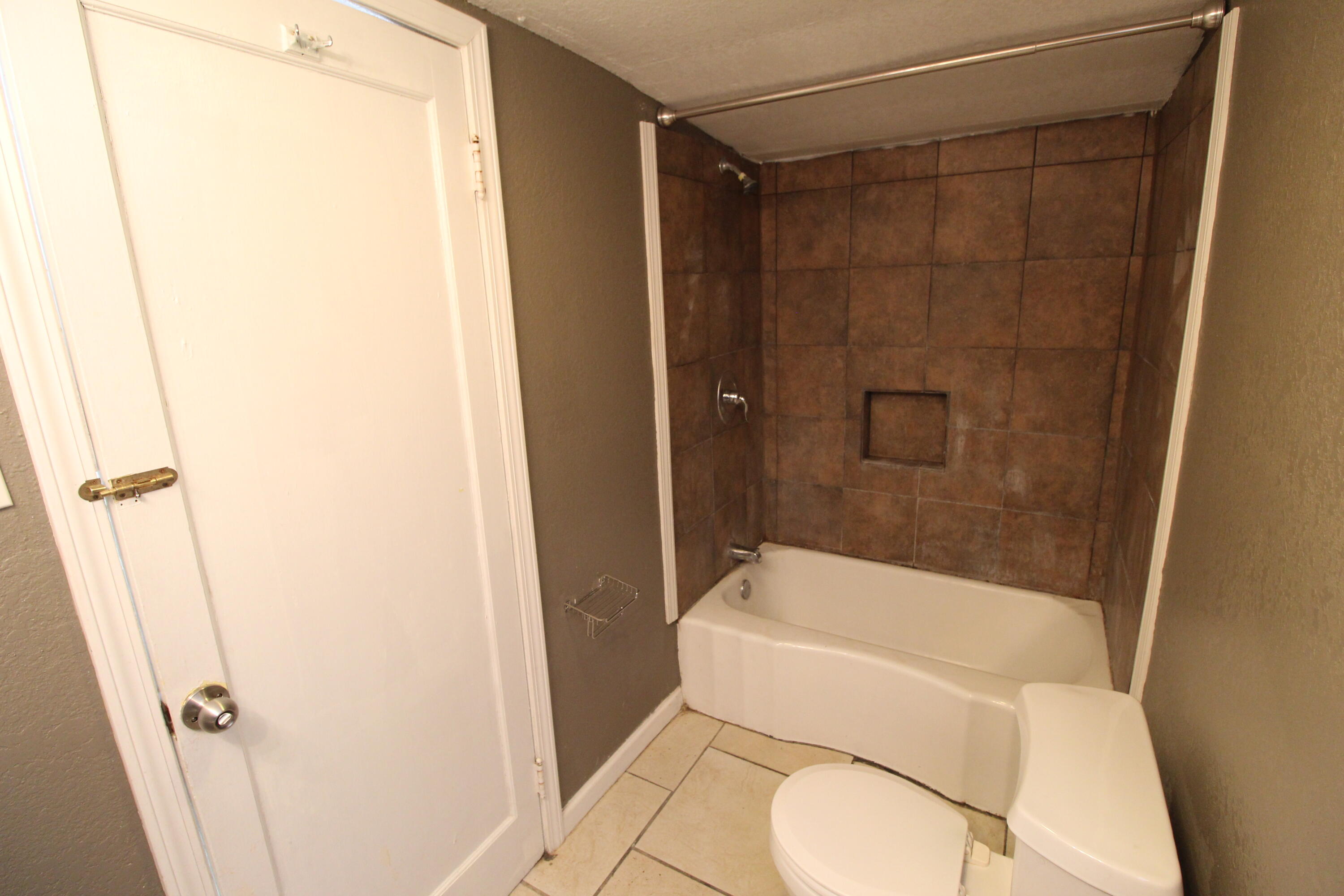 2209 25th Street Lubbock, TX 79411 - Photo 11 of 22 a bathroom with a toilet and shower