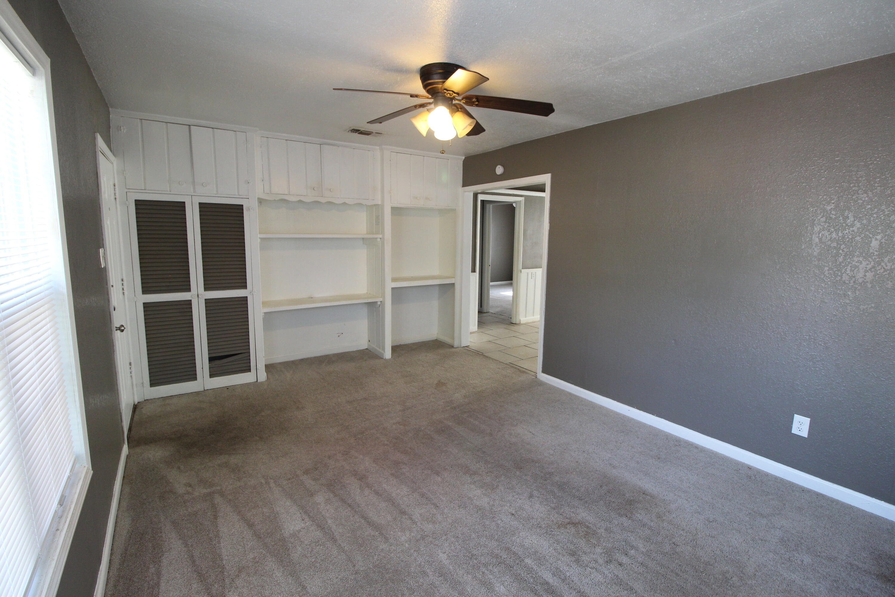 2209 25th Street Lubbock, TX 79411 - Photo 5 of 22 a view of an empty room with a ceiling fan