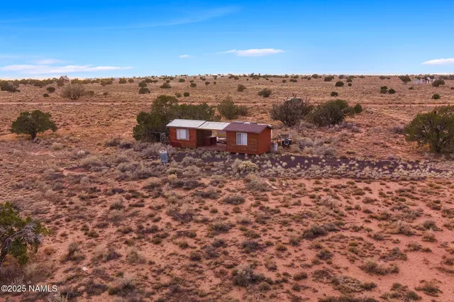 an aerial view of a house with a yard
