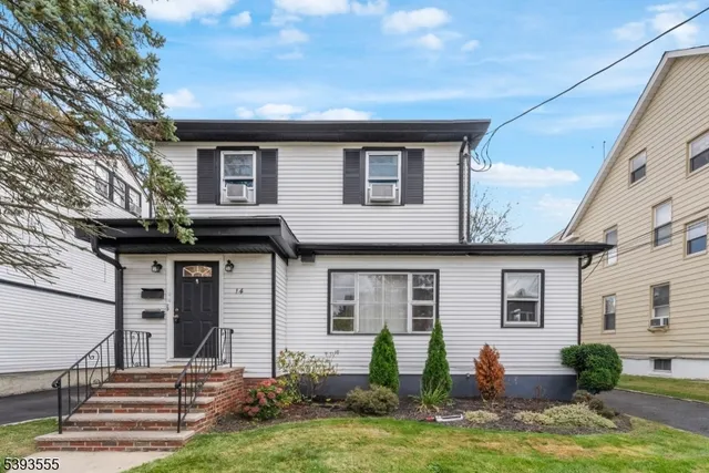 a backyard of a house with yard table and chairs