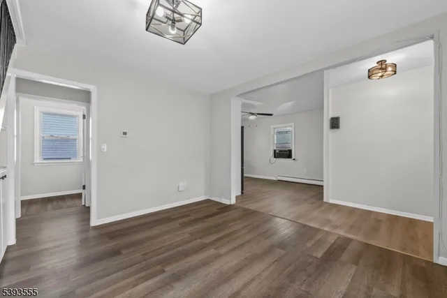 a view of a big room with wooden floor and cabinet