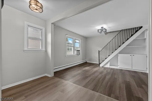 a view of an entryway with wooden floor