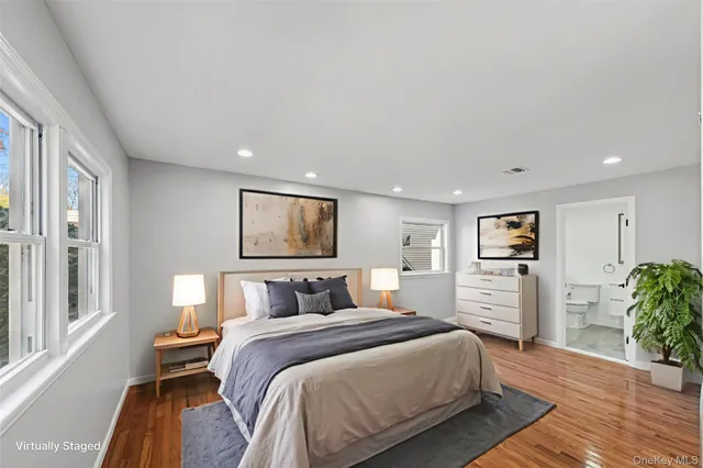 a big room with wooden floor and a bathroom