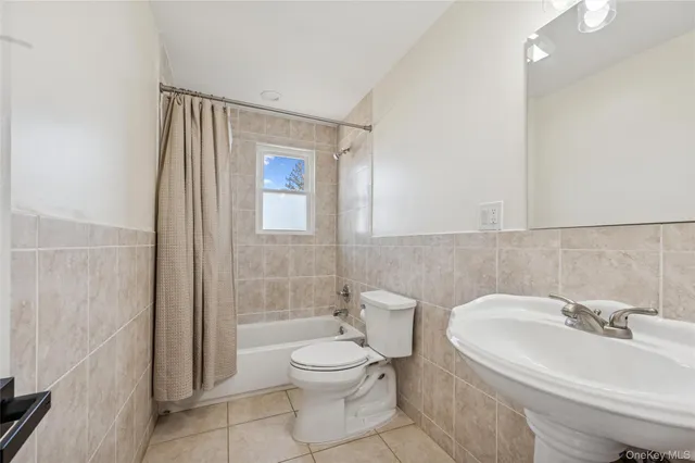 an empty room with window and wooden floor