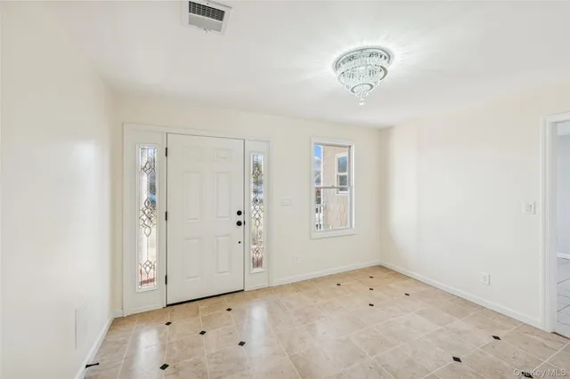an empty room with cabinet and window