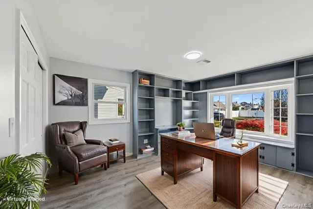 a large white kitchen with kitchen island a sink a stove a refrigerator and a fireplace