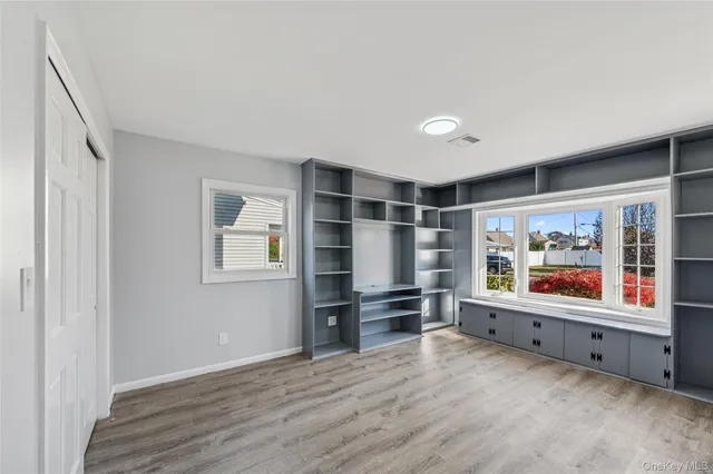 a living room with furniture a rug and a bookshelf
