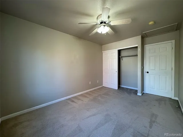 an empty room with a chandelier fan and a chandelier fan