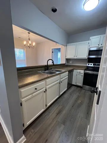 a kitchen with appliances a sink and a stove