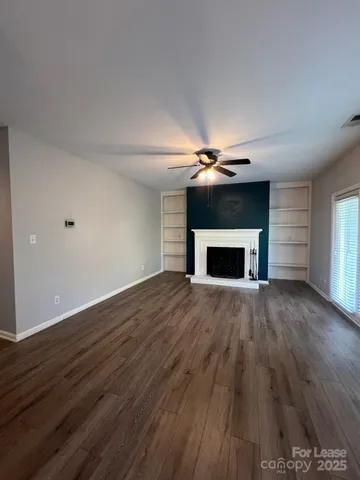 a view of a kitchen with a sink and dishwasher wooden floor