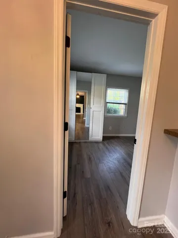 an empty room with windows and closet