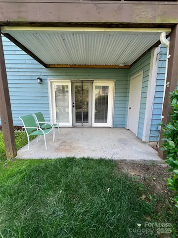 a view of a porch with furniture and garden