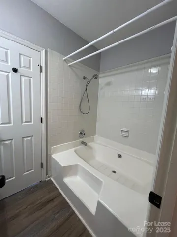 a spacious bathroom with a toilet a sink and mirror