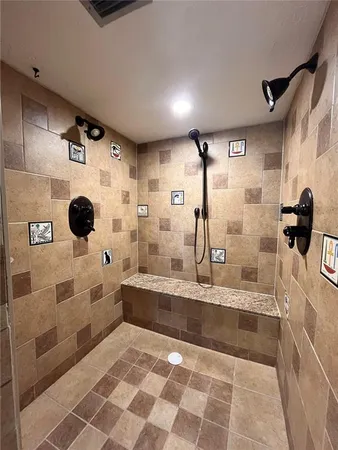 a bathroom with a glass shower door