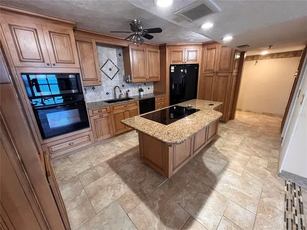 a kitchen with refrigerator and cabinets