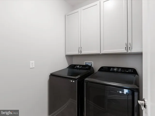 a view of a storage and utility room with washer and dryer