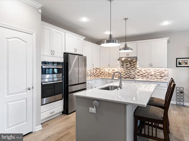 a kitchen with kitchen island a counter and chairs