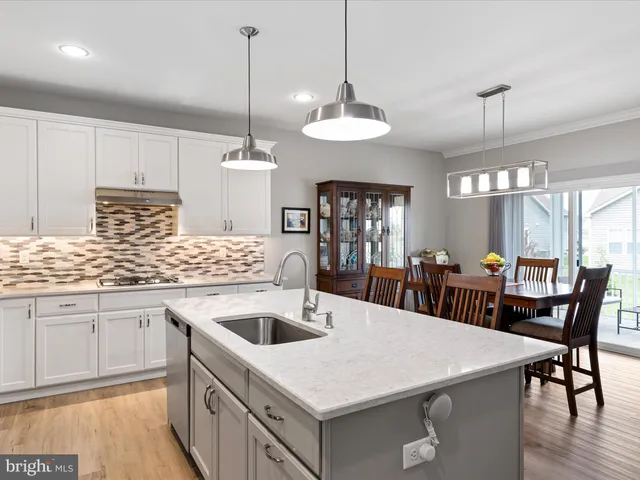 a kitchen with center island table and chairs