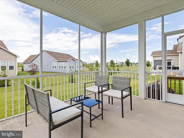 a balcony with furniture and view of city