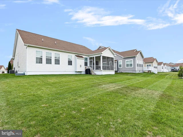 a front view of a house with a garden and plants
