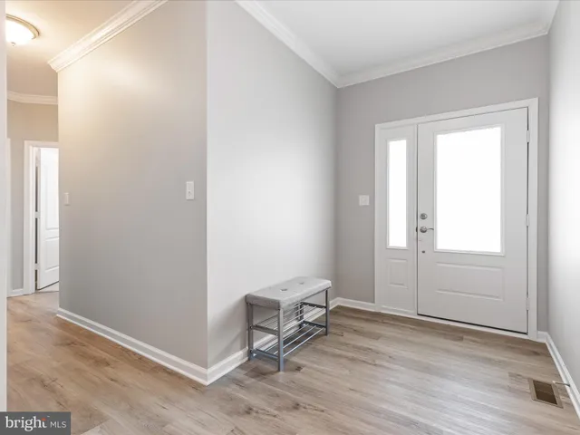 a view of a room with wooden floor and a window