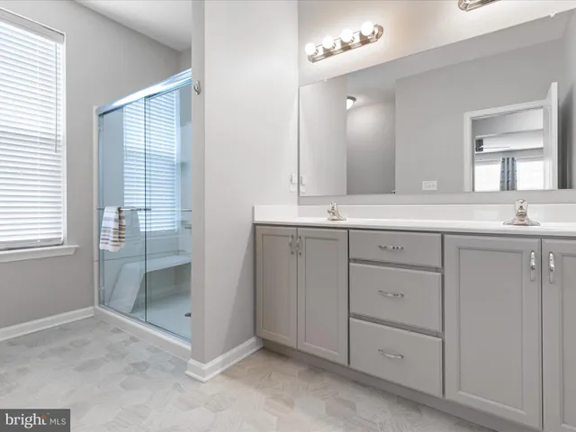 a bathroom with a sink double vanity and a mirror