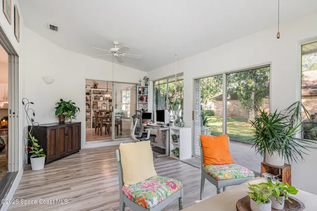 a living room with furniture potted plant and a table