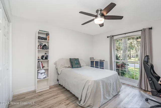 a bedroom with a large bed and a large window