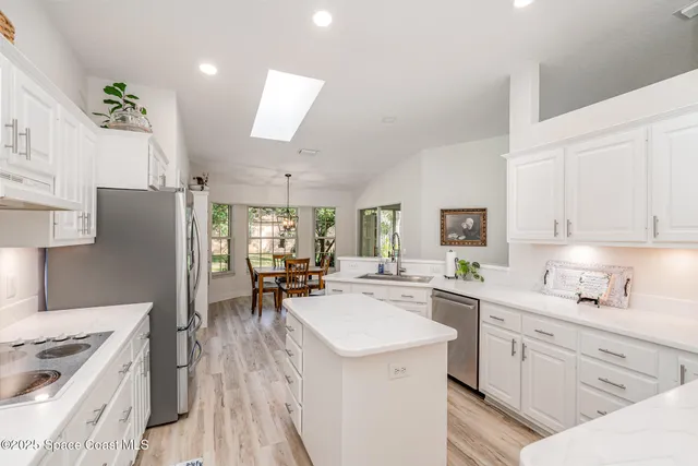 a kitchen with a sink stove and refrigerator